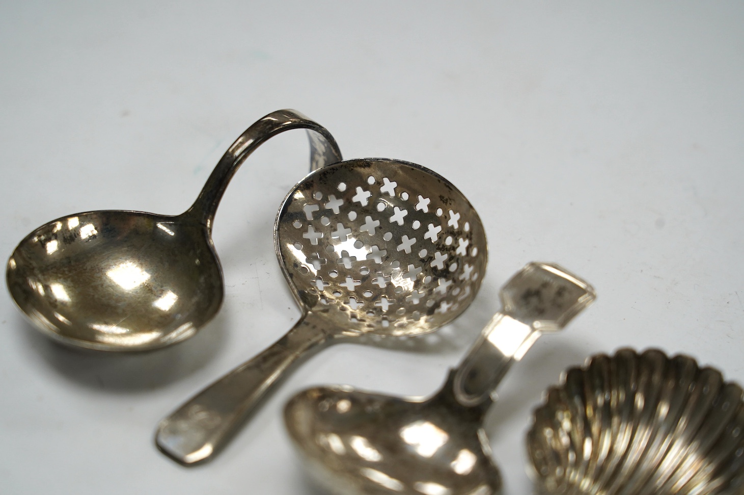 Four assorted silver caddy spoons, including Peter & Ann Bateman, London, 1793, 59mm, reeded handle, Joseph Wilmore?, Birmingham, 1807, pierced bowl, Alice & George Burrows, London, 1809 and curved handle John Lambe, Lon